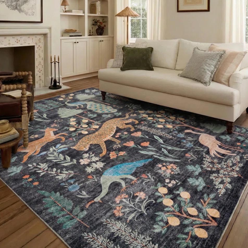 A patterned area rug with colorful animal and botanical designs is placed on a wooden floor in a cozy living room, featuring a white sofa and a fireplace.