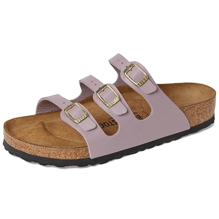 A lilac-colored sandal featuring three adjustable buckled straps, a cork footbed, and a black rubber sole, designed for comfort.