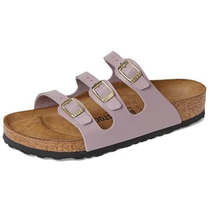 A lilac-colored sandal featuring three adjustable buckled straps, a cork footbed, and a black rubber sole, designed for comfort.