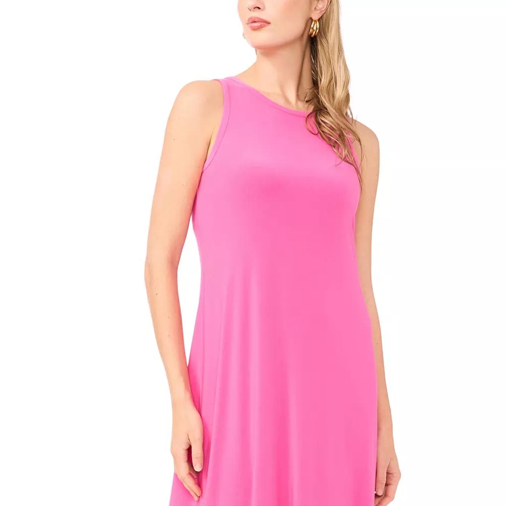 A sleeveless pink dress with a round neckline is being worn by a person with long, blonde hair and gold hoop earrings.