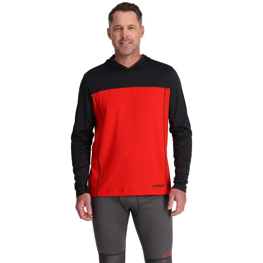 A man wearing a Spyder long-sleeve hoodie with a black top section and vibrant red body, paired with dark gray athletic pants, posing against a plain white background.