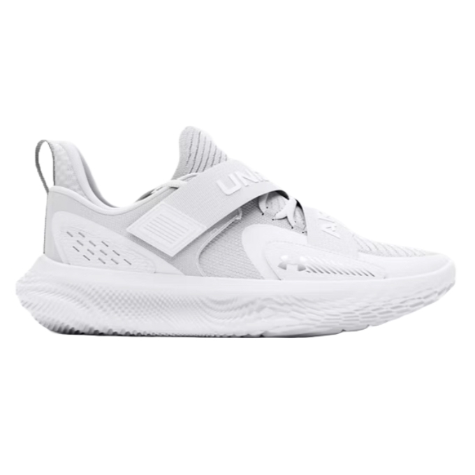 White athletic sneaker with a textured sole, featuring a strap labeled \“UA\“ across the top for secure fit.