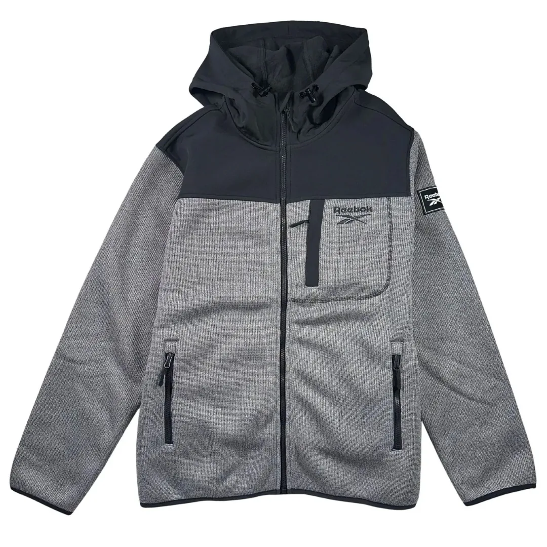 Gray Reebok hoodie with a black upper panel and hood, featuring a front zipper, chest and side pockets, and a logo on the chest and sleeve.