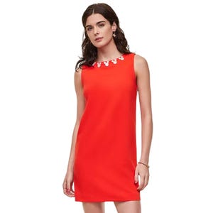 Red sleeveless mini dress with a straight silhouette, featuring a decorative neckline embellished with pearl-like accents.