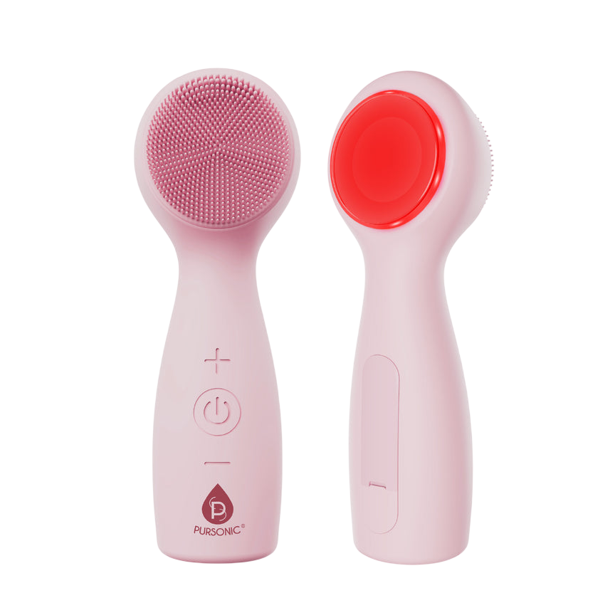 Pink electric facial cleansing brush with a silicone bristle head, featuring +/- buttons and a power button on the handle. The back side has a smooth surface, possibly for additional skin benefits.
