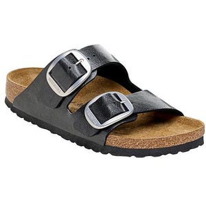 A black leather sandal with a cork footbed and two adjustable buckles on top, featuring a textured rubber sole for grip.