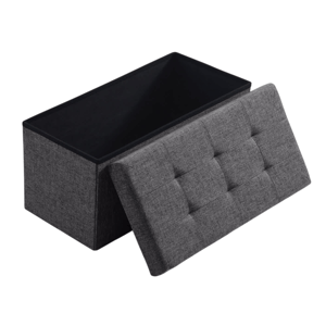 A gray fabric storage ottoman with a tufted lid, partially open to reveal internal storage space.
