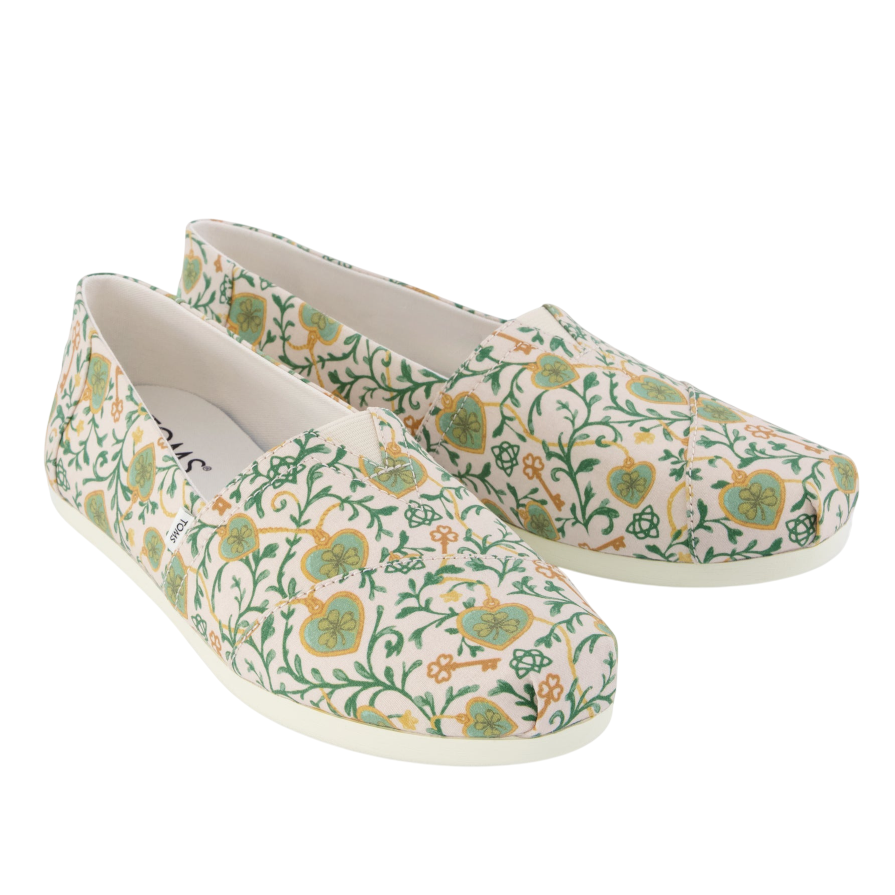 Floral-patterned slip-on shoes with a green and yellow design on a white background.