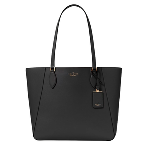 A sleek black Kate Spade New York tote bag with gold-tone hardware and attached tag, featuring long handles and a minimalist design.