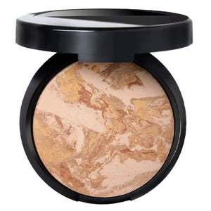 A compact powder with a marbled blend of beige, gold, and light brown shades, encased in a black container with a flip-open lid.