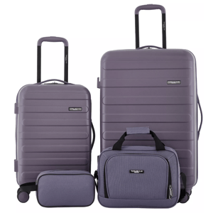 Four-piece purple luggage set includes two suitcases with wheels and retractable handles, a smaller carry-on bag, and a toiletry pouch.