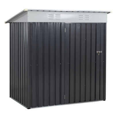 A 6-foot metal storage shed with vertical gray panels, a sloping roof with ventilation grilles, and a front door equipped with a handle.