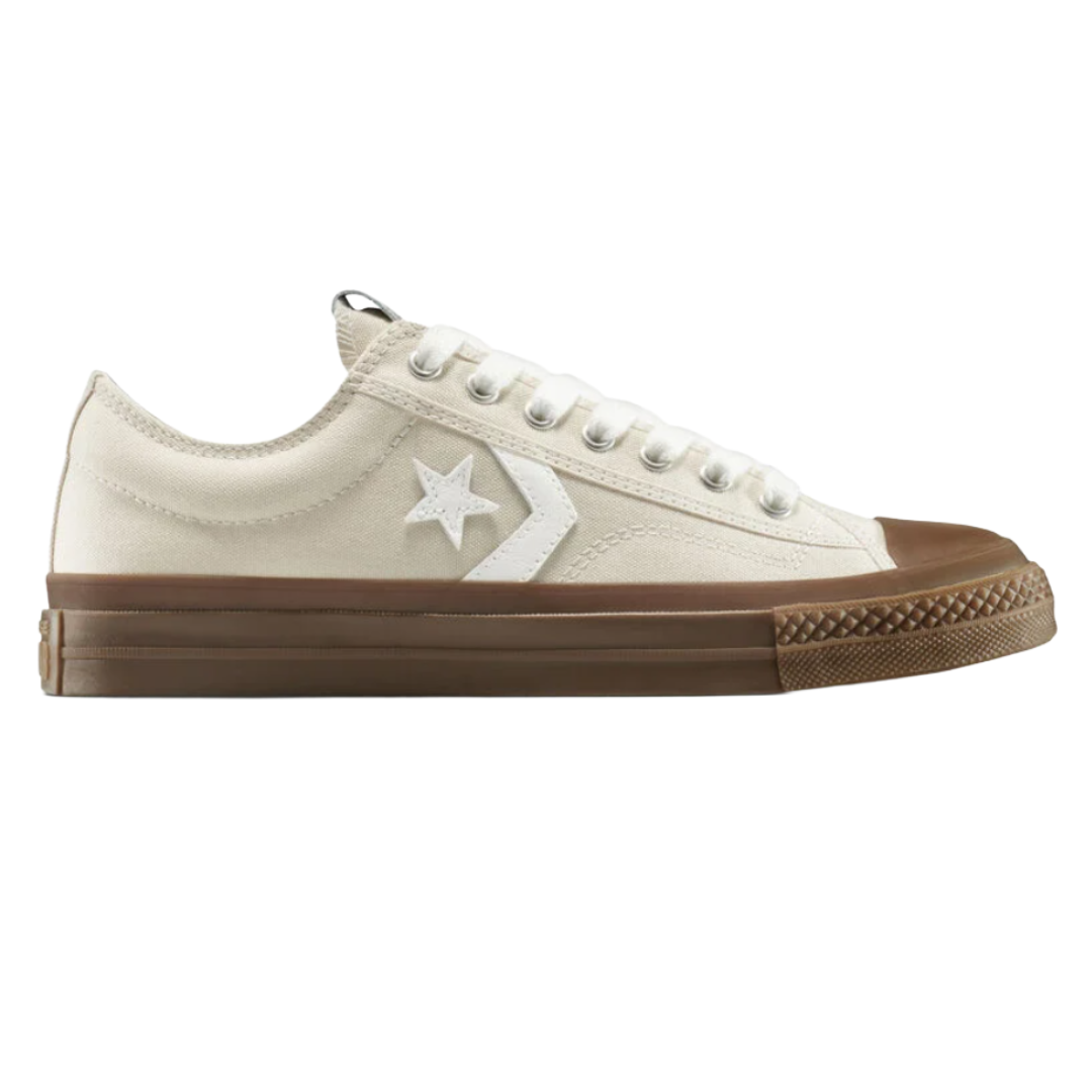 A low-top canvas sneaker with a white upper, featuring a star and chevron logo, and a brown rubber sole.