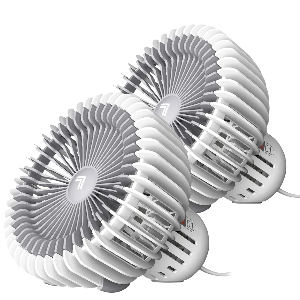 The 2pk Vornado Desktop Fans are compact, cylindrical fans with a white and gray design, featuring circular grills for effective airflow. Each fan is designed for tabletop use and includes a power cord.