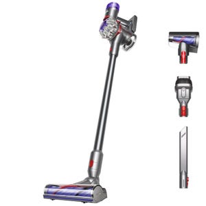 A cordless stick vacuum cleaner with three attachments: a mini motorized tool, a combination tool, and a crevice tool.