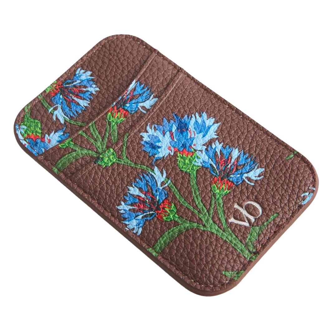 Brown cardholder with a textured surface adorned with a floral pattern featuring vibrant blue and red flowers with green stems.