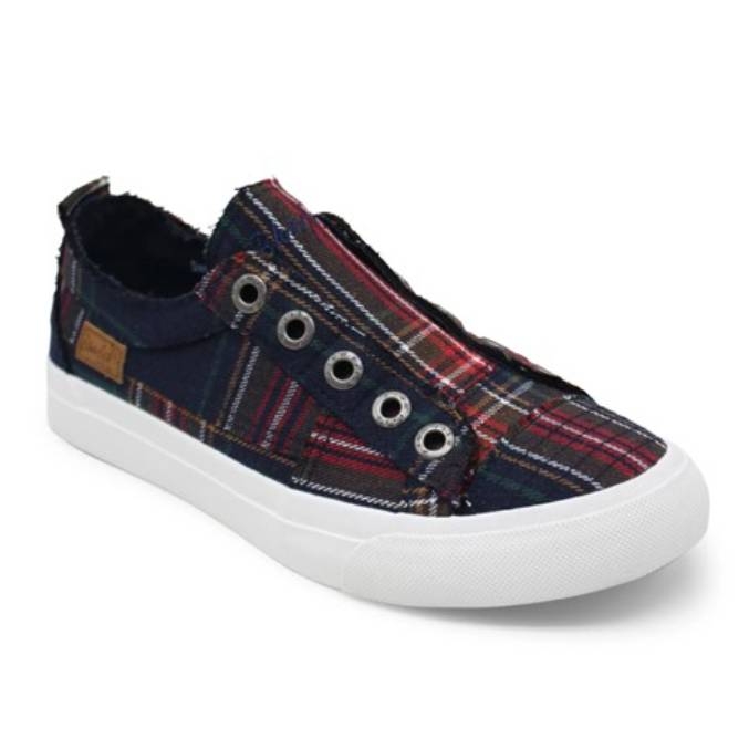 Casual slip-on sneaker with a plaid fabric design, featuring silver eyelets and a white rubber sole.