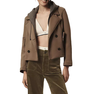 The Maeve Twofer Hooded Peacoat features a double-breasted design in brown, with a detachable hood in contrasting gray. It's paired here with a white bra-style top and olive velvet pants.