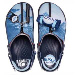 A pair of flip-flops with Busch Light beer branding and a bottle opener attached to one strap.