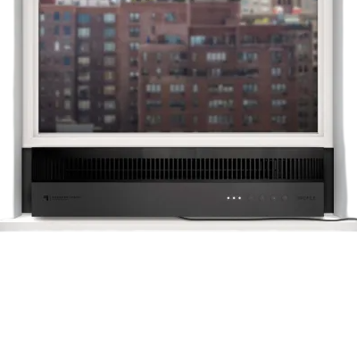 A window air conditioner is installed below a partially open window overlooking a cityscape. The unit features a sleek black design with a visible power cord.