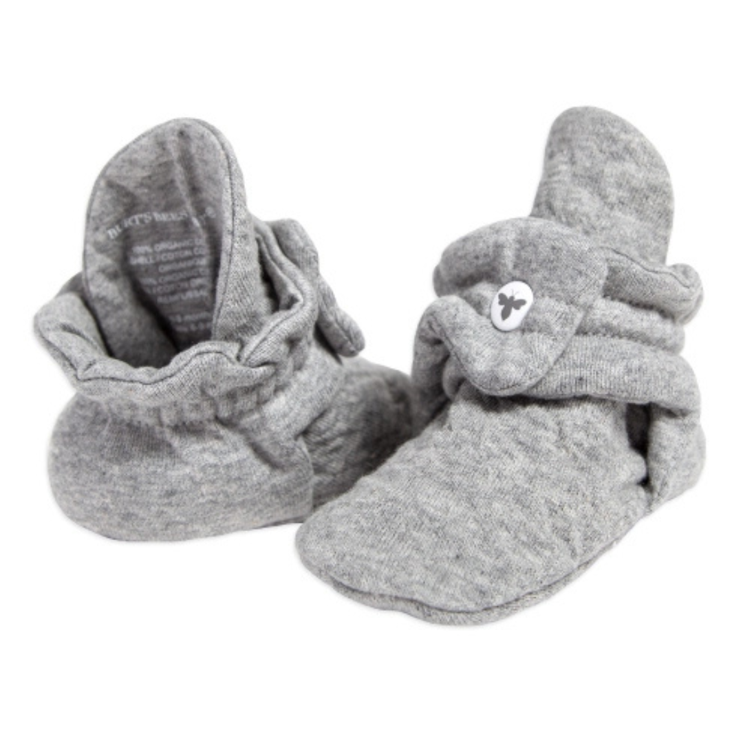 Gray, soft cotton Burt's Bees Baby Booties designed for infants, featuring a fold-over style with a button closure for secure fit.