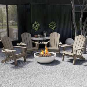 A patio setup featuring four beige Adirondack chairs encircling a fire pit. There is a table with plants and bottled drinks in the background, set against a dark wall.
