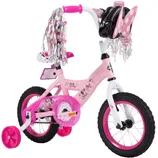 A children's pink and white bicycle with training wheels, handlebar streamers, and Minnie Mouse-themed decorations. It includes a pink handlebar bag with polka-dot bow and heart-shaped tassels.