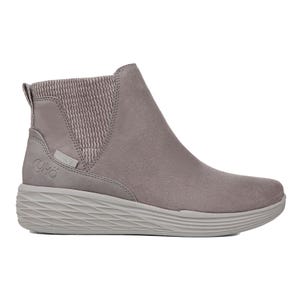 A gray, ankle-high boot with a ribbed elastic side panel and textured sole, featuring \“Ryka\“ branding on the heel.