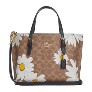 Coach Mollie 25 tote features a brown monogram print with large white daisy patterns, leather detailing, and gold-tone hardware.