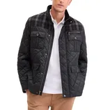 A black quilted jacket with a plaid pattern on the upper section, featuring multiple pockets with button closures and a zipper front. Worn over a white shirt and paired with brown pants.