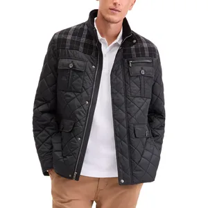 A black quilted jacket with a plaid pattern on the upper section, featuring multiple pockets with button closures and a zipper front. Worn over a white shirt and paired with brown pants.