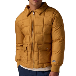The Basin & Range Billy Basecamp Jacket features a mustard yellow color with a quilted design, front zipper, fold-down collar, and two front pockets with button closures, offering a casual, insulated style.