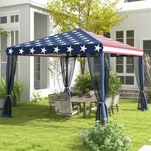 Patriotic-themed 10' x 10' outdoor pop-up canopy with an American flag design, featuring blue sides with white stars and red and white stripes on top. It's set up over a patio dining set in a grassy yard.
