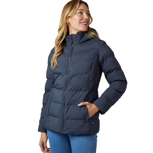 A woman is wearing a puffer jacket with a hood, styled in a dark color, paired with light blue jeans.