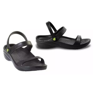 Black sandals with two straps and a low wedge heel, featuring a small green emblem on the side.