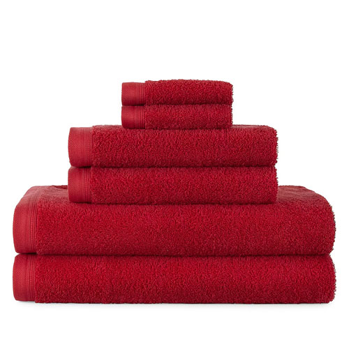 A set of red Home Expressions Solid Bath Towels is shown, including a stack of various sizes: two small, medium, and large towels. They are uniformly colored and neatly arranged.