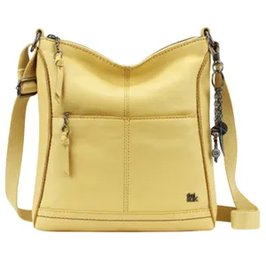 Yellow crossbody bag with a zipper, front pocket, adjustable strap, and decorative charm.