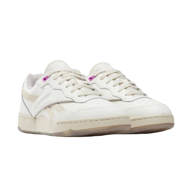 White low-top sneakers with beige accents, featuring laces and a subtle logo on the side.