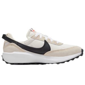 A low-top sneaker with a beige and white color scheme, featuring a black swoosh logo, white laces, and a textured sole for traction.