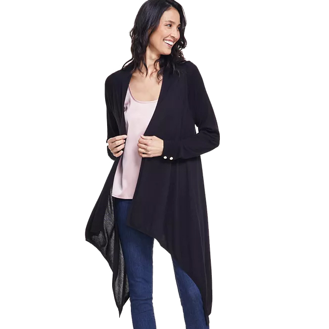 A black INC Waterfall Cardigan with an asymmetrical hem, worn over a light pink top, paired with blue jeans. The cardigan features long sleeves and a flowing design that drapes at the front.