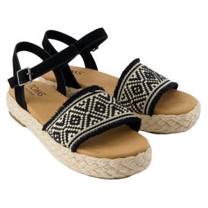Black and beige espadrille sandals with a geometric woven pattern, ankle strap, and braided jute platform sole.