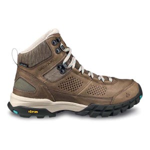 Vasque hiking boot with a brown leather and mesh upper, featuring a Vibram sole for traction and stability, designed for outdoor activities.
