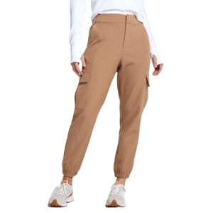 Tan joggers with cargo pockets, featuring a tailored waistline, tapered legs, and elastic cuffs. Paired with white sneakers and a white long-sleeve top.