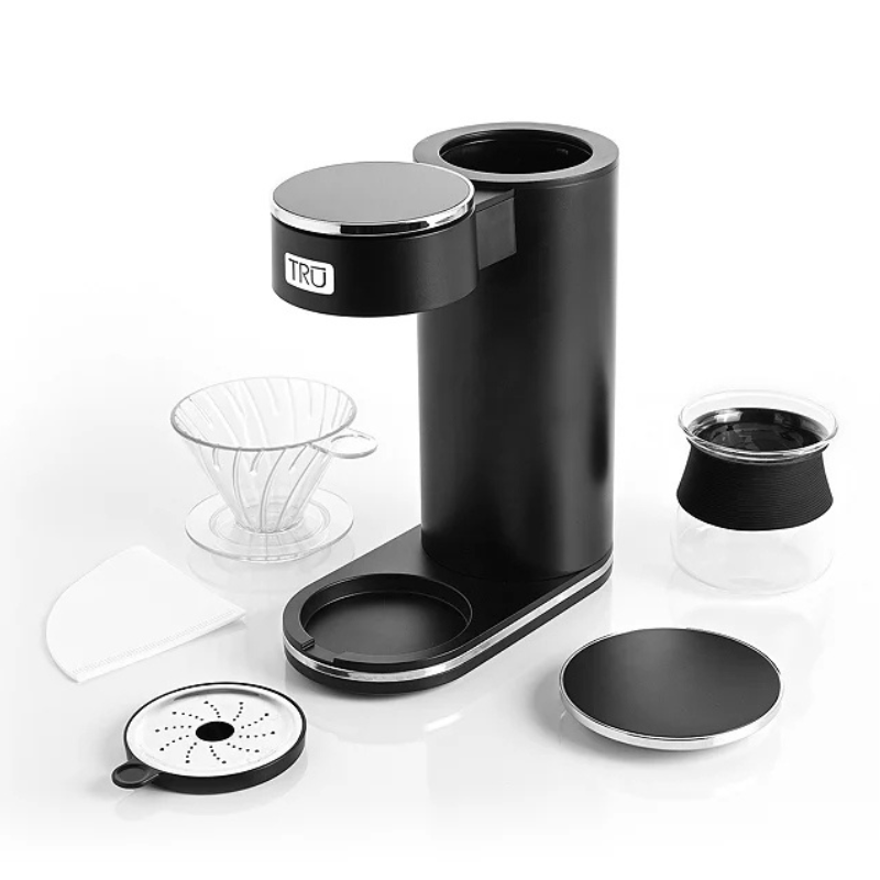 A black TRU coffee maker set with a drip stand, glass carafe with a black grip, dripper, filters, and a detachable drip tray.