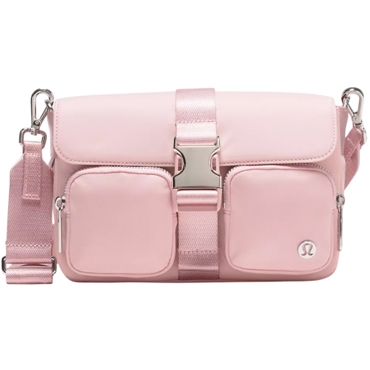 Pink lululemon Multi-Pocket Crossbody with a secure metal buckle, adjustable strap, and two front zip pockets.