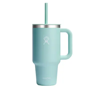 A mint green Hydro Flask mug with a handle, stainless steel rim, and matching straw, featuring the brand's logo.