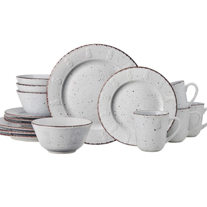 A speckled dinnerware set featuring plates, bowls, and mugs with a rustic design.