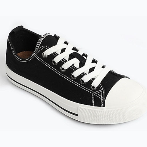 Black and white low-top canvas sneaker with white laces and rubber sole.