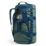 A green and blue duffel bag with a cylindrical shape, featuring adjustable shoulder straps, buckles, and a small transparent pocket on the side.