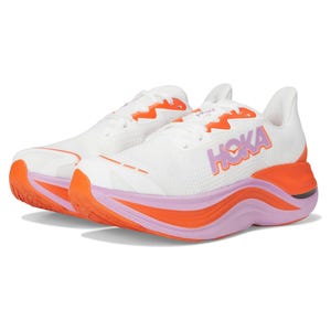 White Hoka Skyward X women's running shoes feature a breathable mesh upper, vibrant orange and purple accents, and a thick, cushioned sole designed for comfort and support during runs.